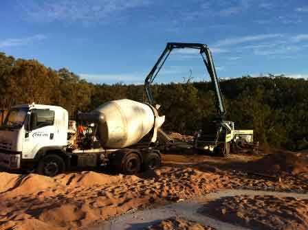 Inspecting the footings being poured